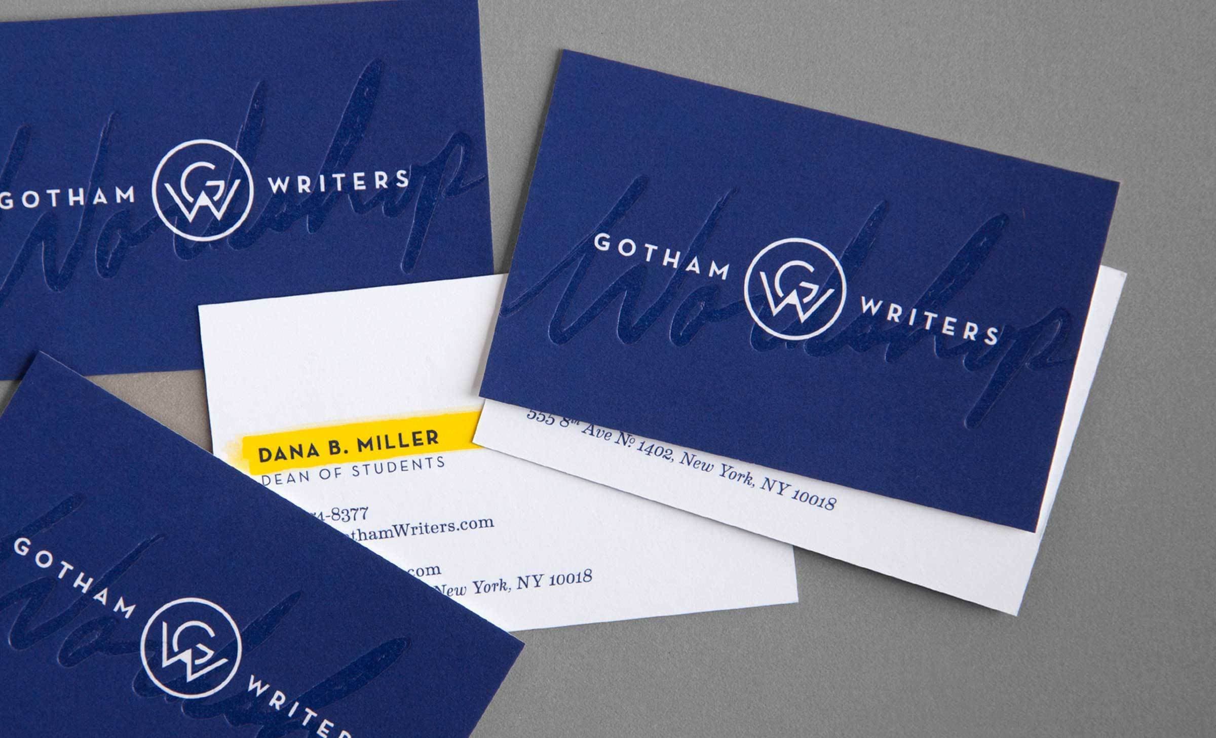 A spread of blue Gotham Writers business cards with embossed logos, along with a white contact card for Dana B. Miller, Dean of Students. The contact card displays a phone number and an address in New York, NY. The blue cards also feature the Gotham Writers logo.