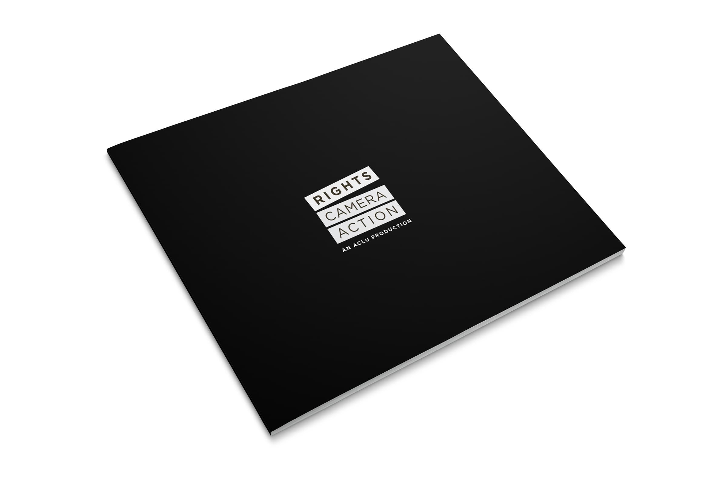 A black square booklet is pictured with the text "Rights Camera Action" and "An ACLU Production" in white letters on the cover. The booklet is placed on a white surface.