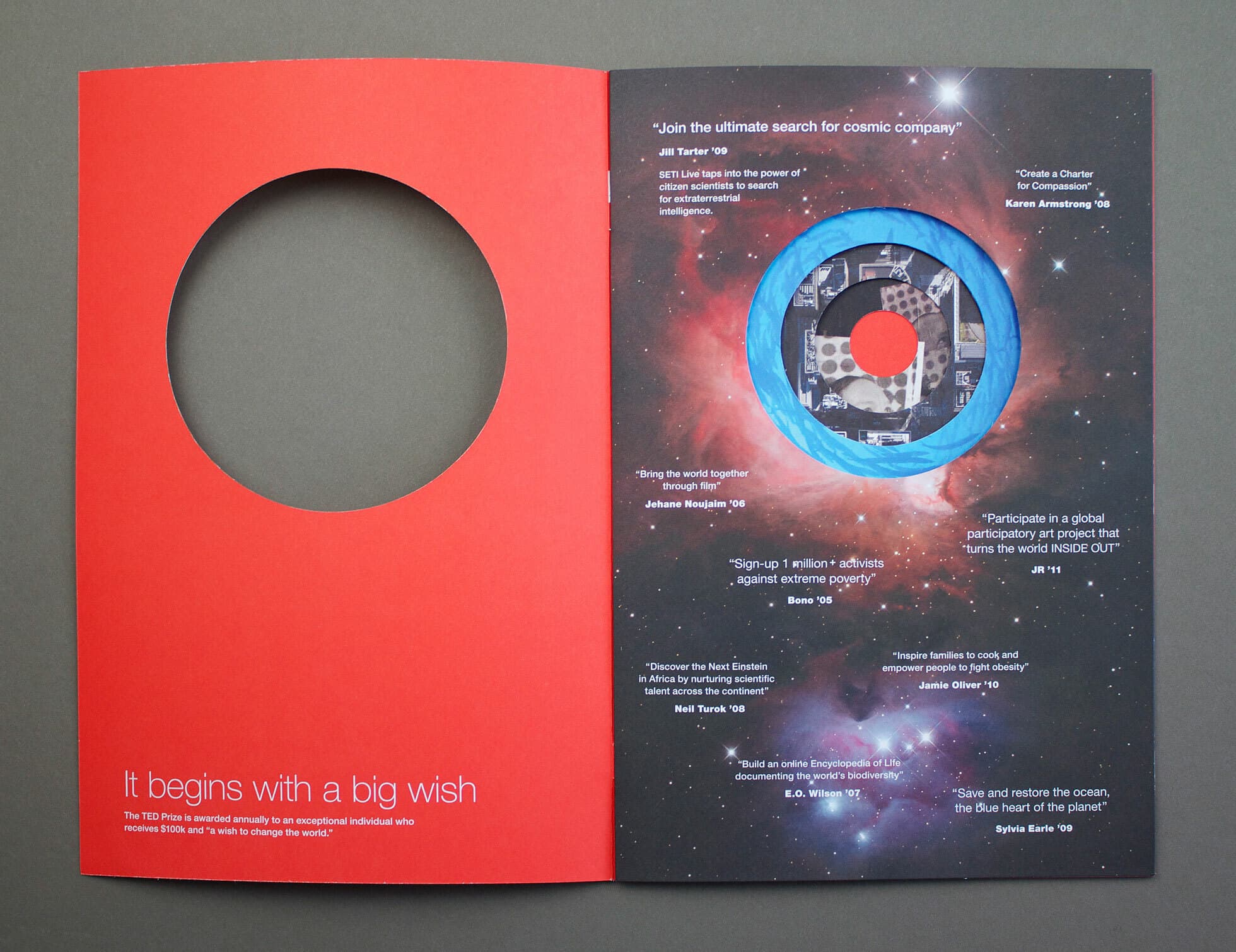 An open book features a red left page with a large circular cut-out and white text at the bottom: "It begins with a big wish." The right page shows an image of space with a round cut-out revealing a blue border and circular text inside discussing cosmic exploration.