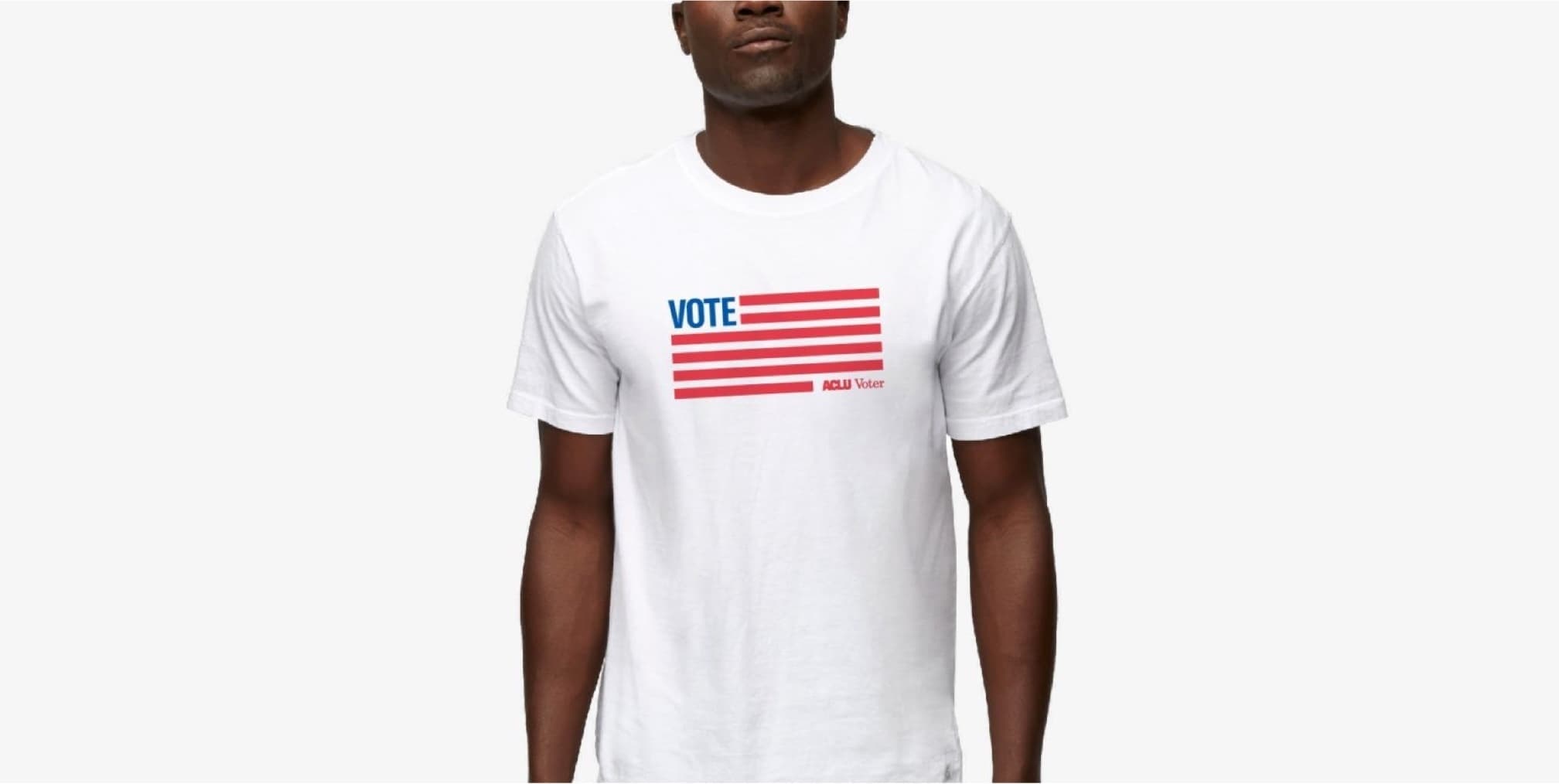 A person wearing a white T-shirt with a design resembling the American flag. The flag's stripes are red, and the upper left corner contains the blue word "VOTE" instead of stars. Below the stripes, in small red letters, it reads "ACLU Voter.