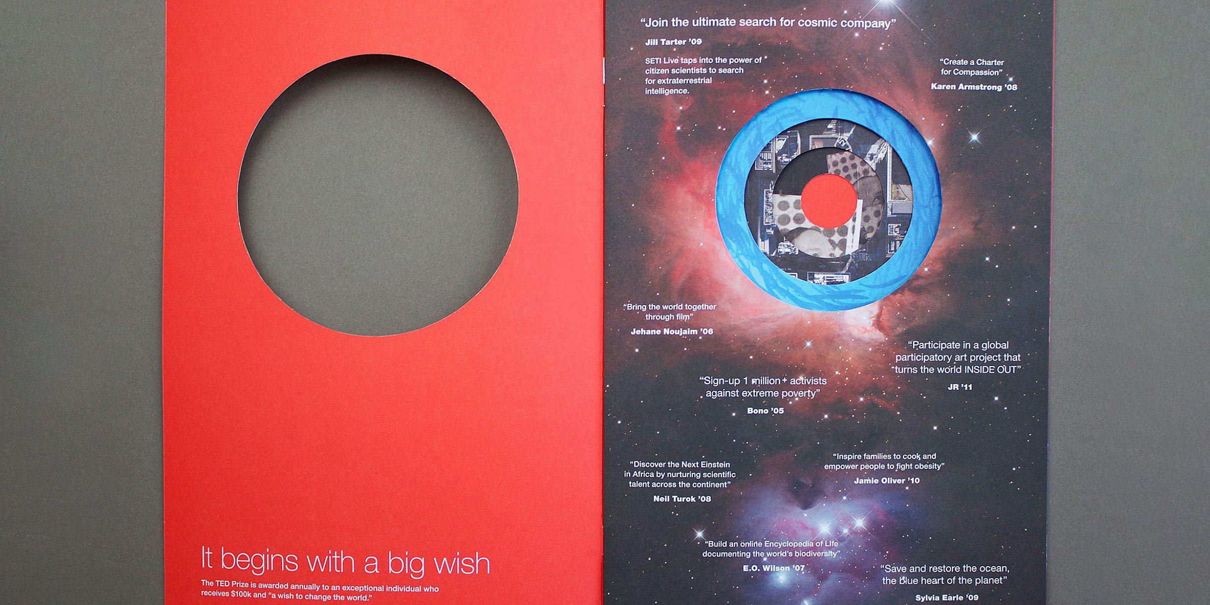 A two-page brochure on a dark gray surface. The left page is red with a large circular cutout and reads "It begins with a big wish." The right page has a cosmic background with a circular image of the Earth, overlaid with various white text quotes about space exploration.