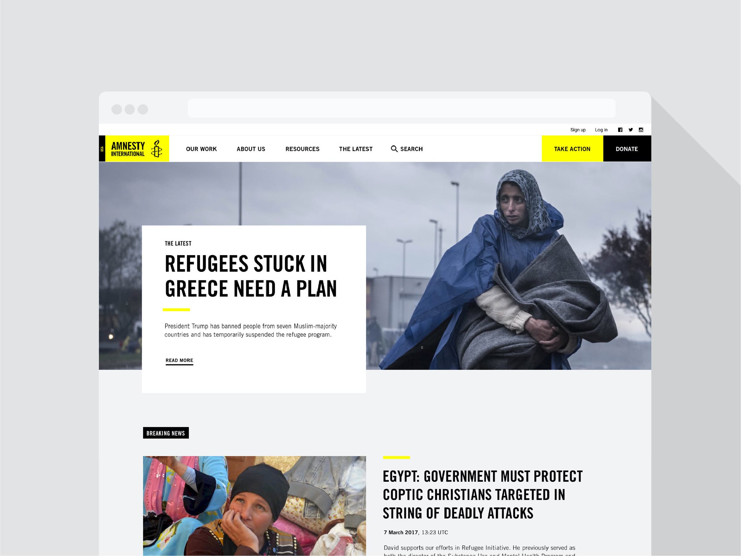 A webpage from Amnesty International. The headline reads "REFUGEES STUCK IN GREECE NEED A PLAN." Below is an image of a person in warm clothing sitting outdoors. Additional news headlines and navigation options are visible on the page.