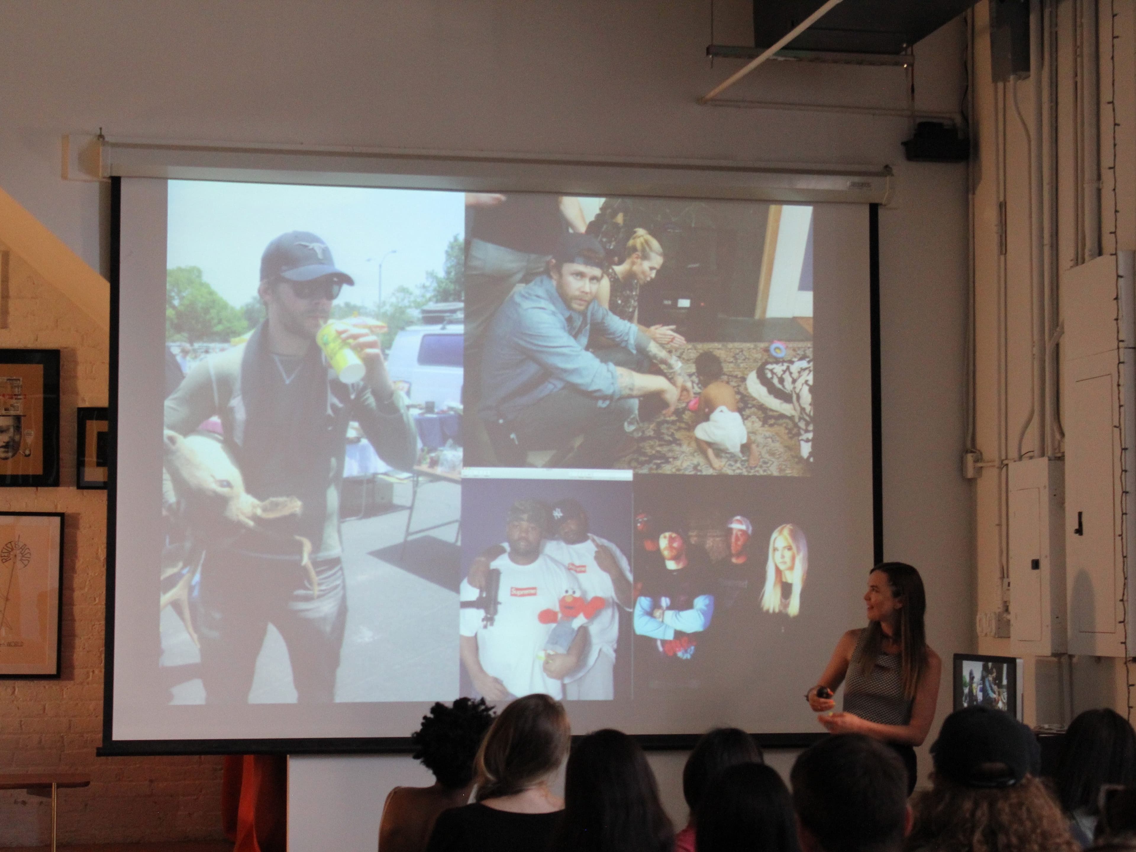 A woman stands in front of a group of people, presenting to an audience with a slideshow projected behind her. The slideshow features multiple photos of people engaging in various activities, including holding animals, eating food, and posing outdoors.