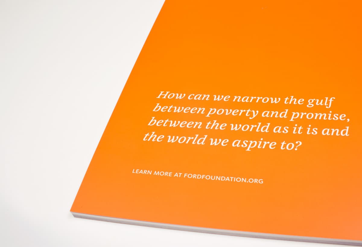 An orange book cover with white text that reads, "How can we narrow the gulf between poverty and promise, between the world as it is and the world we aspire to?" Below is a smaller text: "Learn more at fordfoundation.org".