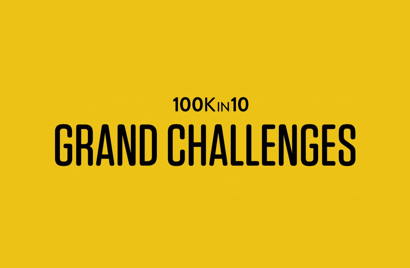 A yellow background with bold black text centered that reads "100Kin10 GRAND CHALLENGES".