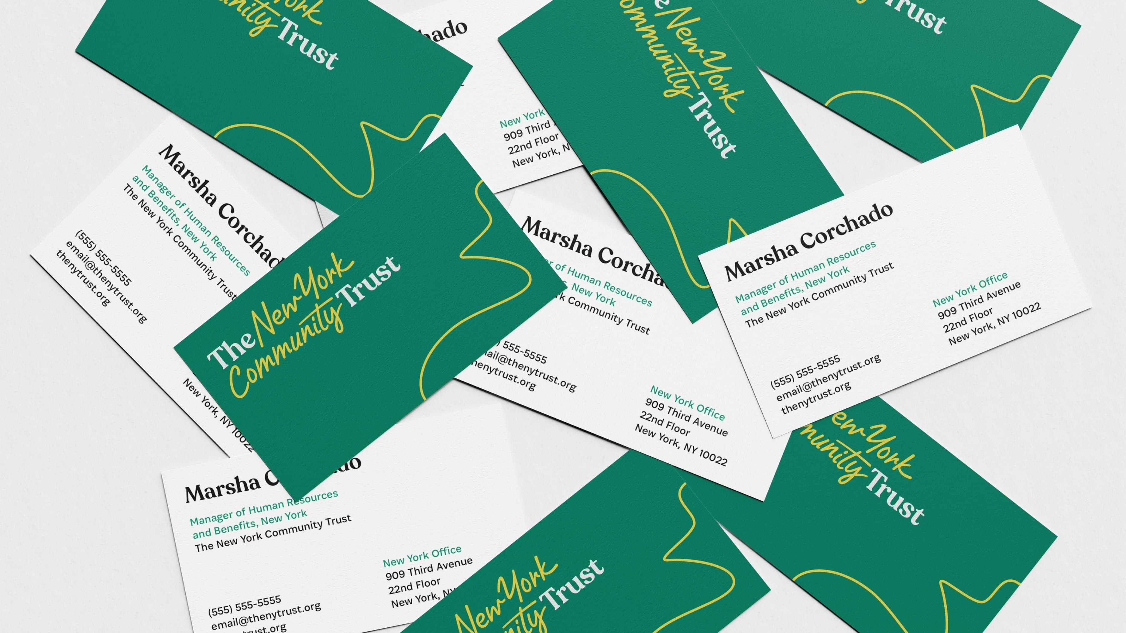 Scattered business cards for Marsha Corchado, Manager of Fund Administration at The New York Community Trust. Cards feature contact information and a green backdrop with the organization's name in yellow.