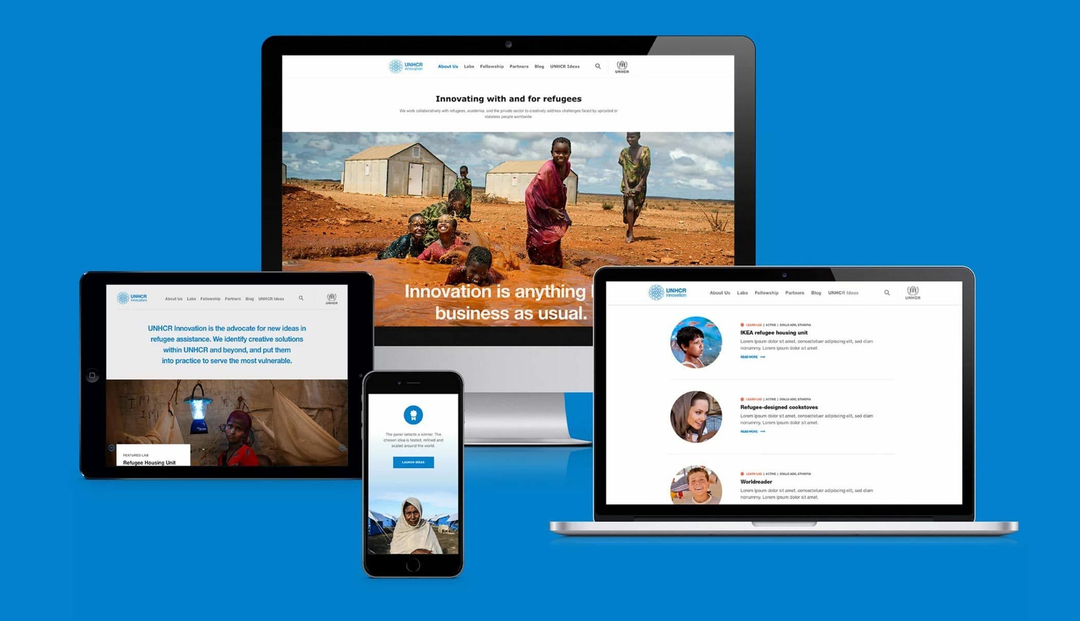 A blue background displays five devices: a smartphone, two tablets, and two laptops, all showcasing a website dedicated to innovation and support for refugees. The website features images of refugees, text, and various sections about UNHCR’s efforts and initiatives.