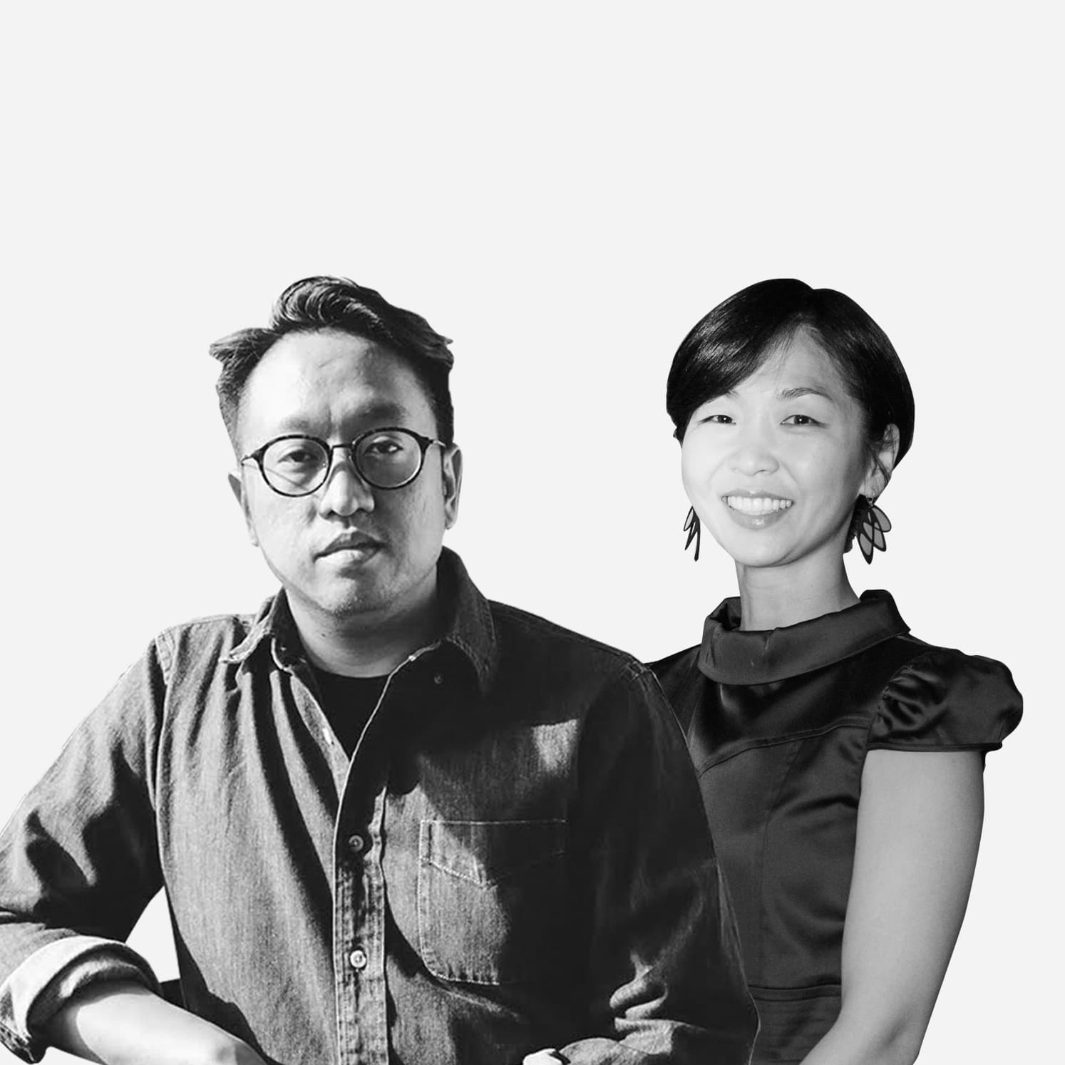 A black and white image depicts two individuals. On the left, a person with glasses, short hair, and a button-up shirt looks directly at the camera. On the right, a person with short hair wearing a dress smiles warmly. Both are posed against a plain background.
