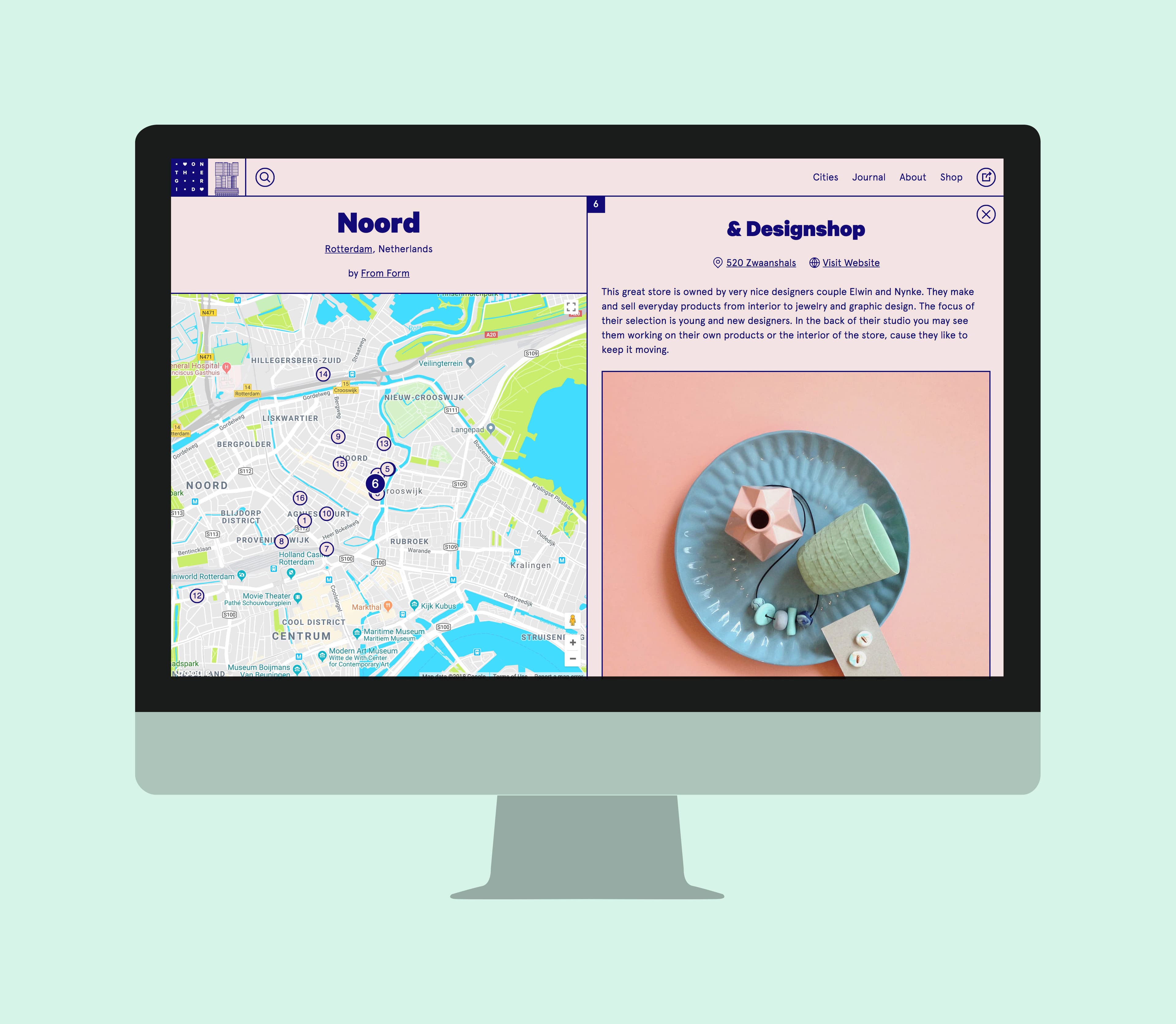 A computer monitor displays a webpage split into two sections: the left side shows a map of Rotterdam, emphasizing the "Noord" area, while the right side highlights a shopping destination named "& Designshop" with a photo of pastel-colored decor items.
