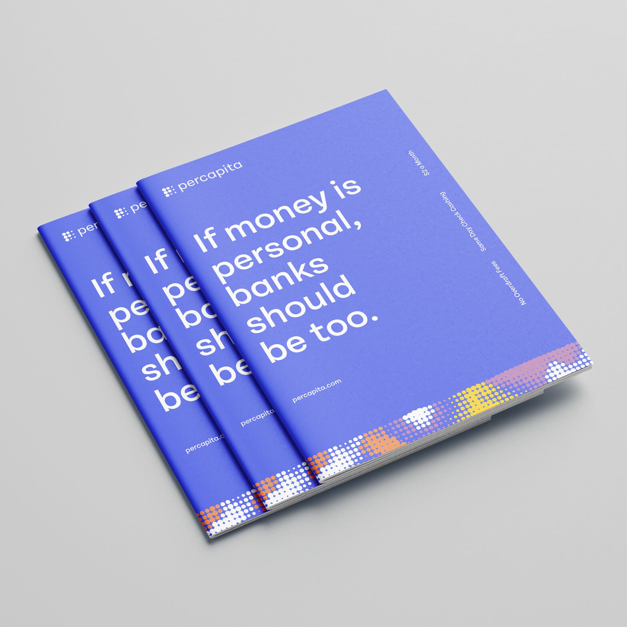 Three blue booklets with the title “If money is personal, banks should be too” are stacked on a light grey surface. The booklets have the company name "percopita" in the top left corner and a design with white, orange, and yellow squares at the bottom.