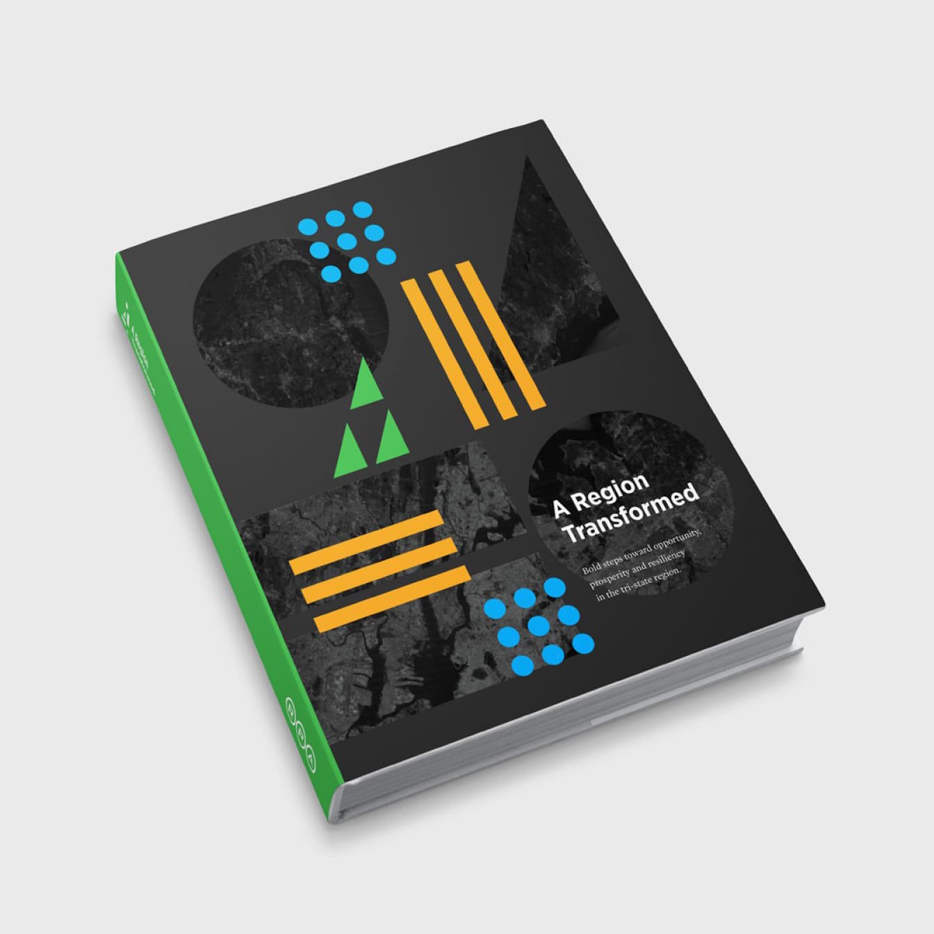A hardcover book titled "A Region Transformed" is displayed at an angle against a white background. The cover is black with geometric patterns and shapes in green, blue, orange, and gray. The spine is green with white text.