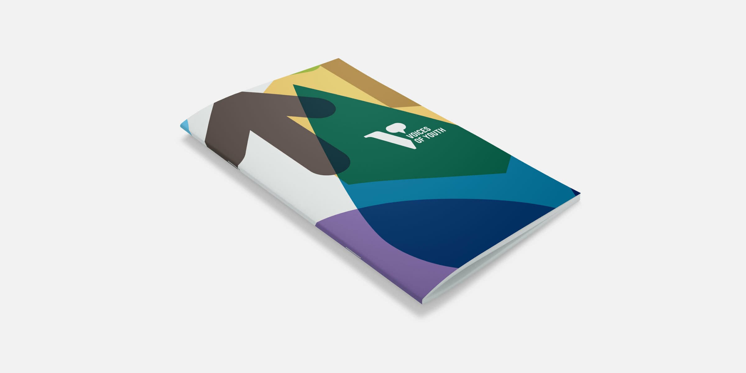A colorful booklet on a white background. The cover design features an abstract pattern of shapes in green, blue, purple, yellow, and brown. The top right of the booklet has a white "V" and "Spaces of Pattern" text in a modern font.