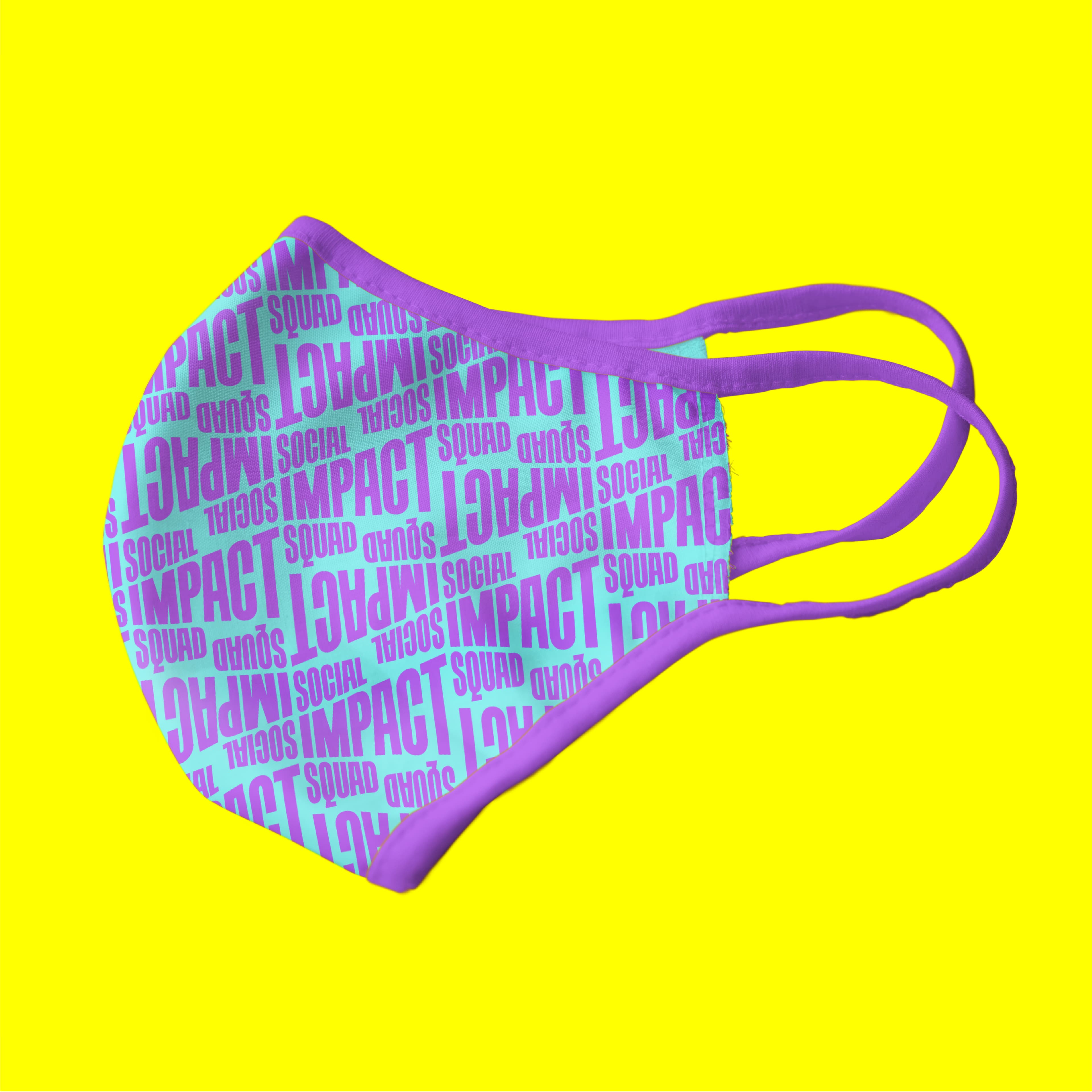 A purple face mask with pink edges lies on a bright yellow background. The mask is covered in repeating text in bold pink and blue fonts that read "IMPACT," "Social," and "SQUAD" in various orientations.