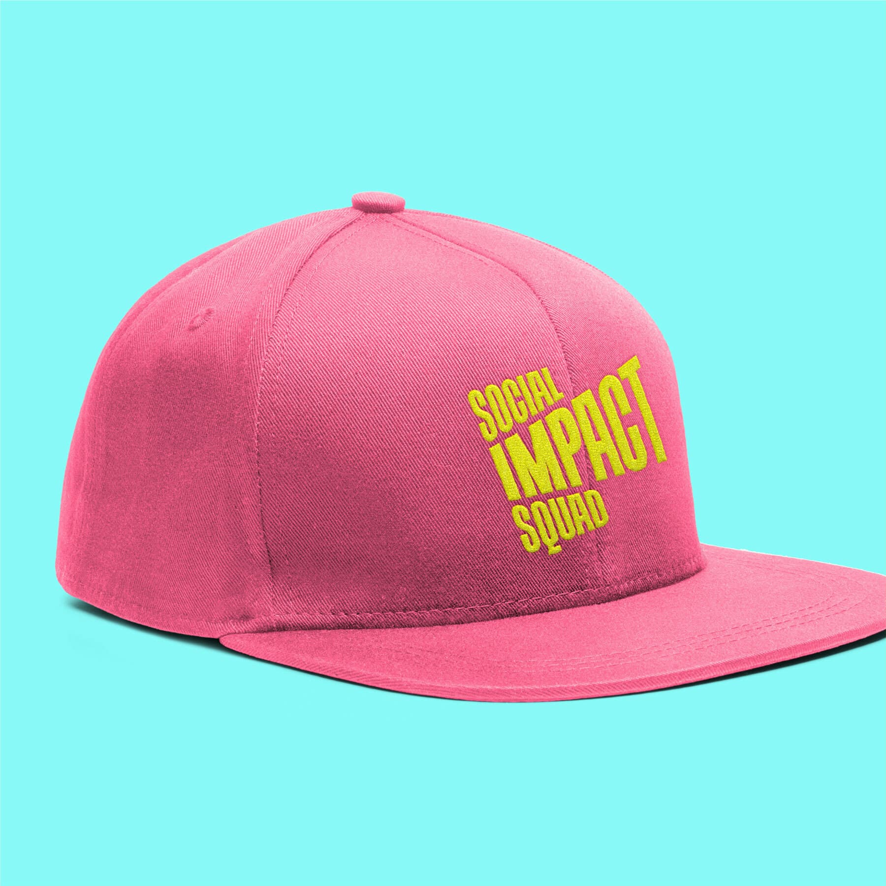A pink baseball cap with the words "SOCIAL IMPACT SQUAD" printed in bold yellow letters on the front. The cap is shown against a light blue background.